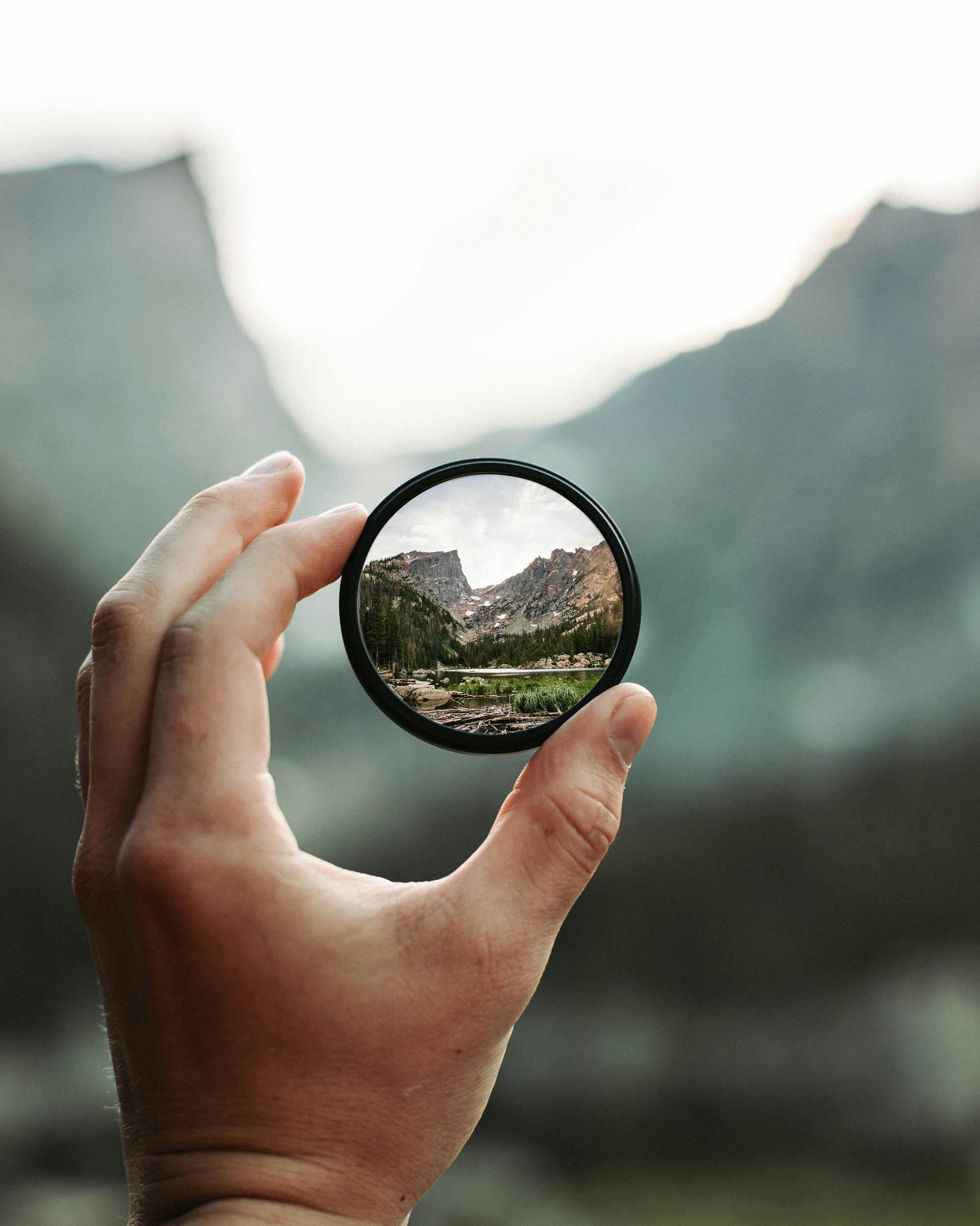 A stunning mountain landscape magnified through a handheld lens highlighting exploration and adventure.